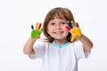 Happy smiling beautiful little girl with her colorful hands in the paint isolated on white background Royalty Free Stock Photo