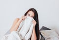 Happy smiling beautiful long hair asian girl young woman lying down in bed, cozy morning Royalty Free Stock Photo