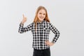 Happy smiling beautiful teen girl showing thumb up gesture, standing over white background in casual shirt Royalty Free Stock Photo