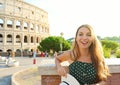 Happy smiling beautiful tourist girl in Rome with Colosseum on the background at sunset. Summer holidays in Italy Royalty Free Stock Photo