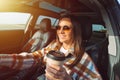 Happy smiling beautiful woman holding coffee cup and driving a car on a sunny day Royalty Free Stock Photo