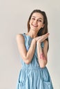 Happy smiling beautiful woman in polka dot dress posing in studio