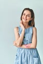 Happy smiling beautiful woman in polka dot dress posing in studio