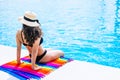 Happy smiling bikini woman enjoy relax sitting at swimming pool summer vacation. Tourist girl enjoy holiday chilling at luxury Royalty Free Stock Photo