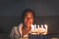 Happy smiling birthday woman ready to blow out lit birthday cake candles. Royalty Free Stock Photo