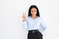 Happy smiling black businesswoman doing victory sign on white background Royalty Free Stock Photo