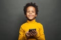Happy smiling black child boy with smartphone
