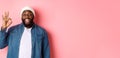 Happy smiling Black guy showing okay sign, approve and praise good offer, standing over pink background Royalty Free Stock Photo