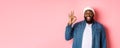 Happy smiling Black guy showing okay sign, approve and praise good offer, standing over pink background Royalty Free Stock Photo