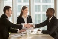 Happy smiling black and white businessmen handshaking after sign Royalty Free Stock Photo