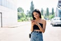 Happy smiling black woman looking at her smartphone walking in the city Royalty Free Stock Photo