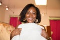 Smiling black young woman bride trying on wedding dress for marriage Royalty Free Stock Photo