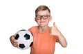 Happy smiling blond child boy in pink T-shirt with soccer ball showing thumb up isolated on white background. Winner kid Royalty Free Stock Photo