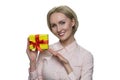 Happy smiling blond woman holding present box in her hand. Royalty Free Stock Photo