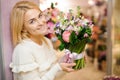 Happy smiling blonde woman with a large valentine bouquet