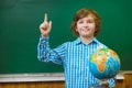 Happy smiling boy on blackboard background . Educational and school concept Royalty Free Stock Photo