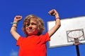 Happy smiling boy celebrating victory with hands in the air Royalty Free Stock Photo