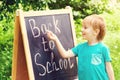 Happy smiling boy is going to school for the first time. Back to school. Kid writes on blackboard. School, kid, education Royalty Free Stock Photo