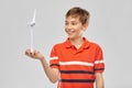 Happy smiling boy holding toy wind turbine Royalty Free Stock Photo