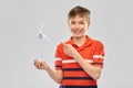 Happy smiling boy holding toy wind turbine Royalty Free Stock Photo