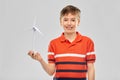 Happy smiling boy holding toy wind turbine Royalty Free Stock Photo