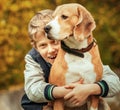 Happy smiling boy hugs his best freind beagle dog Royalty Free Stock Photo