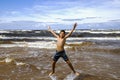 Happy smiling boy jumping in the waves of the Baltic Sea Royalty Free Stock Photo