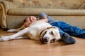 happy smiling boy playing and sleeping with old labrador retriever dog. Boy and large dog at home. Child and friendship Royalty Free Stock Photo