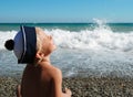 Happy smiling boy sits on seaside Royalty Free Stock Photo