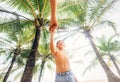 Happy smiling boy take for hand his father under palm trees