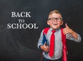 Happy smiling boy in uniform with book and bag. Surprised kid in glasses go back to school. Success, motivation, winner Royalty Free Stock Photo