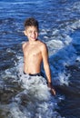 Happy smiling boy in the waves of the Baltic Sea