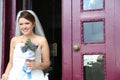 Happy and smiling bride at the entrance of hotel