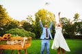 Happy smiling bride and groom hands releasing white doves on a s Royalty Free Stock Photo
