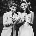 Happy smiling bride and groom holding white doves on a sunny day Royalty Free Stock Photo