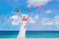 Happy smiling bride on the wedding day on tropical beach an