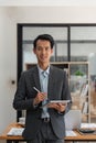 Happy smiling business man company executive ceo manager wearing suit at desk in office working on laptop computer at Royalty Free Stock Photo