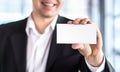 Happy smiling business man holding empty white business card Royalty Free Stock Photo