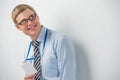 Happy smiling business man showing blank badge, while leaning on wall Royalty Free Stock Photo