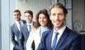 Happy smiling business team standing in a row at office. Royalty Free Stock Photo