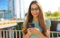 Happy smiling business woman with mobile phone in the street Royalty Free Stock Photo