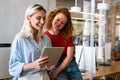 Happy smiling business women working together online on a tablet in office Royalty Free Stock Photo