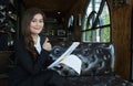 Happy smiling businesswoman with thumbs up gesture looking at camera sitting on a sofa Royalty Free Stock Photo