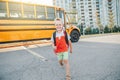 Happy Smiling Caucasian Boy Elementary Student Running Near Yellow Bus On First September Day. Education And Back To School In
