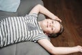 happy smiling Caucasian boy is lying upside down on his home sofa Royalty Free Stock Photo