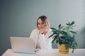 Happy smiling Caucasian business woman working on laptop computer. Freelancer working remotely on Internet from home office. Royalty Free Stock Photo