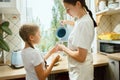 The happy smiling caucasian family in the kitchen preparing breakfast Royalty Free Stock Photo