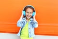 Happy smiling child enjoys listens to music in headphones Royalty Free Stock Photo