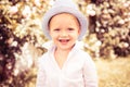 Happy smiling child on the green grass in summer park. Baby face closeup. Funny little kid boy close up portrait. Blonde Royalty Free Stock Photo