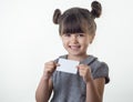 Happy smiling child holding discount white card in her hands. Kid with credit card. Royalty Free Stock Photo